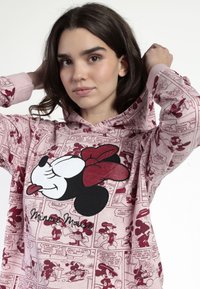 Sudadera rosa con un atrevido gráfico de Minnie Mouse en negro y rojo, patrones de tira cómica, textura suave y capucha con cordón.