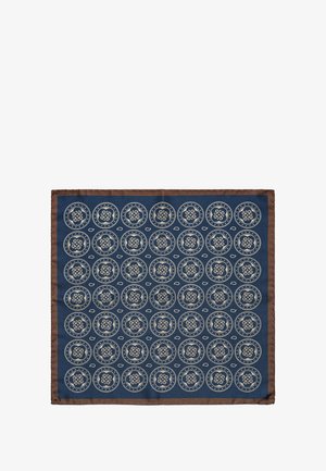 Tummansininen kangassammu, jossa on pyöreitä kermavärisiä kuvioita ja ruskea reuna. Sisältää monimutkaisia kuvioita ja pehmeän pinnan.