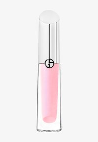 Clear lipgloss i en cylindrisk glasbehållare med ett silverlock med en rund topp och en svart logga; mjuk rosa produkt inuti.