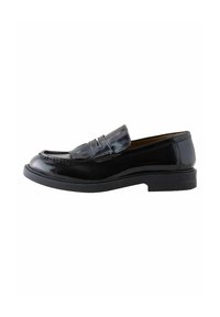 Black patent leather loafer with a rounded toe, decorative fringe detail, and a low, textured rubber sole. Classic slip-on design.