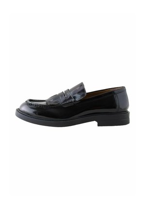 Black patent leather loafer with a rounded toe, decorative fringe detail, and a low, textured rubber sole. Classic slip-on design.