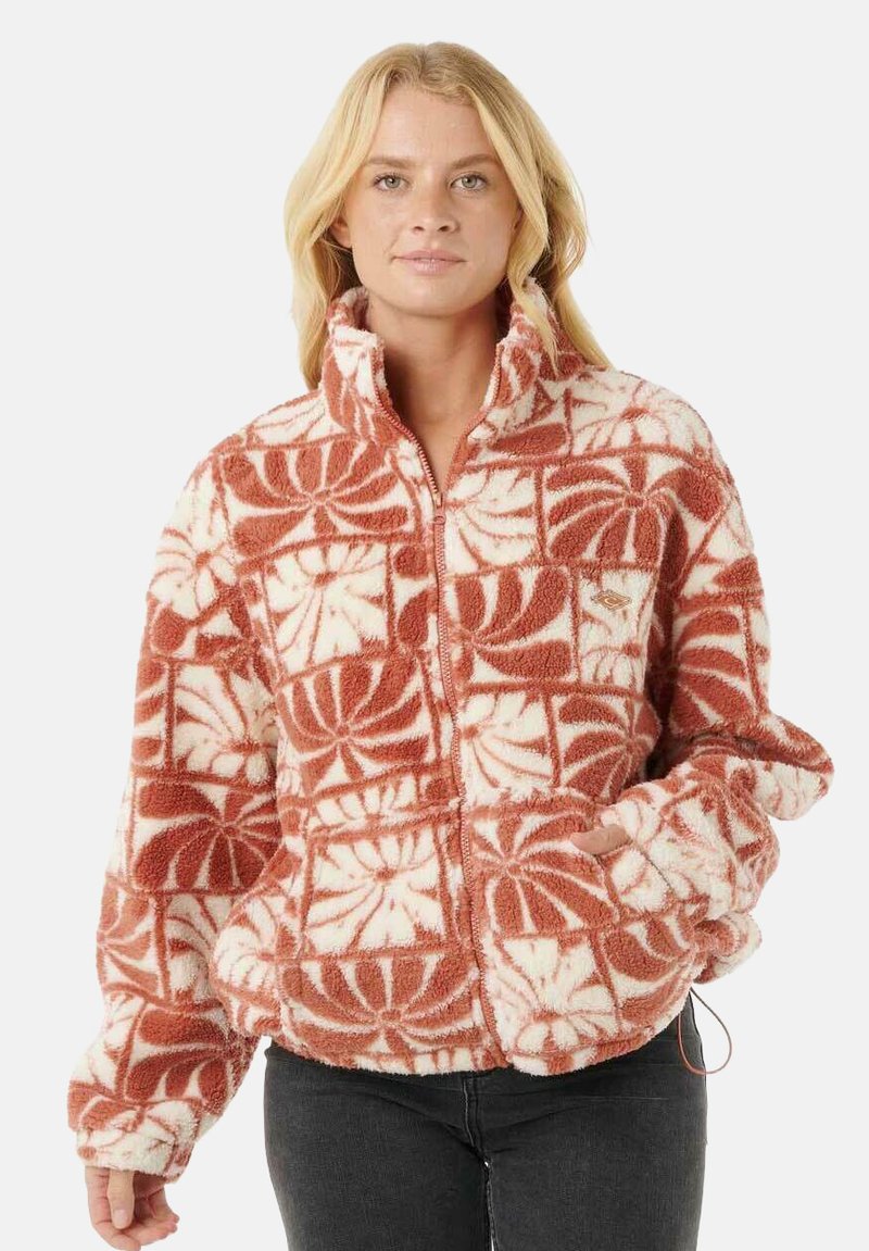 Fleece-Reißverschlussjacke in Orange und Weiß, mit floralem Muster und hohem Kragen. Die Textur ist weich und plüschig, mit elastischen Bündchen.