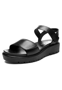 Sandalia de plataforma de cuero negro con puntera abierta, tiras gruesas en el frente y el tobillo, y suela estriada para mayor agarre.