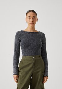 Langsleeve top in donkergrijs, gemaakt van zachte stof met een gestructureerde afwerking. Kenmerkt zich door een brede halslijn en gegolfde mouwranden.