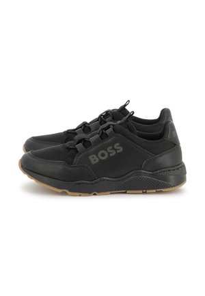 Black sneakers made of mesh and synthetic materials, featuring a textured sole, elastic laces, and a subtle logo on the side.