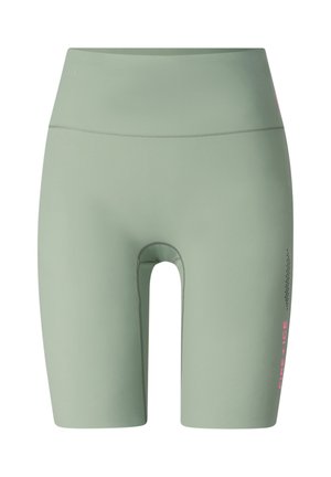 Jasnozielone, krótkie spodenki kolarskie z wysokim stanem, płaskimi szwami i małym różowym napisem "RINE ICE" na prawym udzie.
