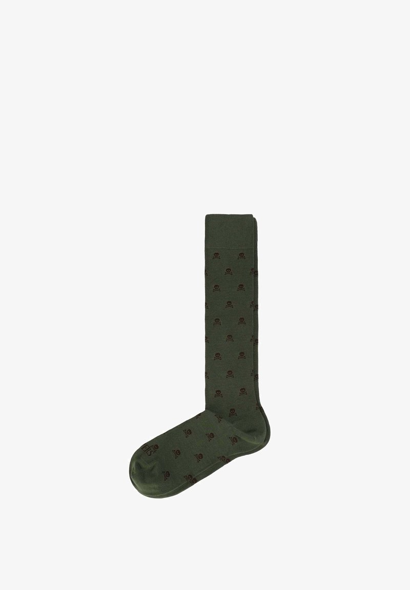 Chaussettes montantes de couleur vert foncé avec une texture douce, présentant un motif répété de crânes en marron. Partie supérieure unie avec un pied à motif.