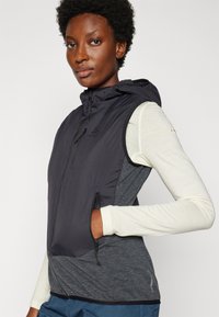 Black and gray sleeveless vest with a hood, made of lightweight material. Features side pockets and a front zipper.