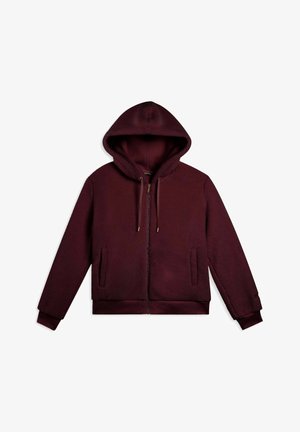 Felpa con zip color bordeaux, dotata di cappuccio regolabile con coulisse, due tasche laterali e polsini a costine. Tessuto morbido con un design casual.