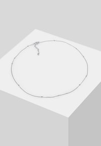 Silver necklace with a delicate chain, featuring small round beads spaced along its length. Includes a lobster clasp and adjustable chain.