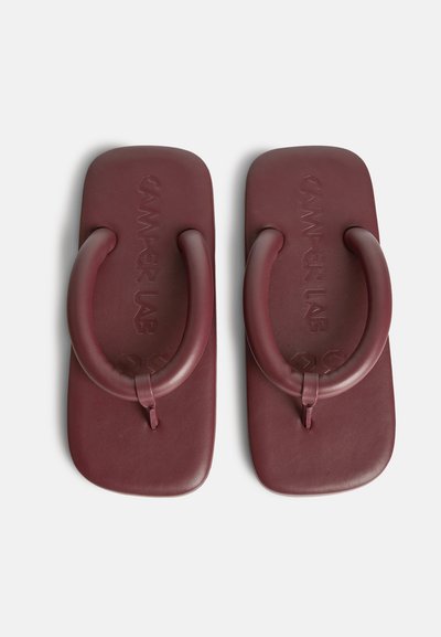 Burgundy flip-flops i gummi med en kraftig design, som har en texturerad fotbädd och överdimensionerade runda remmar för ökat stöd.