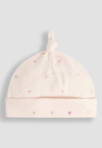 Chapeau en coton rose clair avec un nœud sur le dessus, comportant un motif brodé de petits cœurs roses et beiges sur le corps principal.