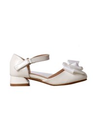 Chaussure enfant en cuir verni blanc avec petit talon bloc, bride à la cheville et nœud décoratif sur l’avant.
