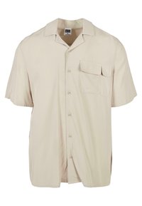 Chemise à boutons beige à manches courtes avec col camp et poche à rabat sur la poitrine gauche, étiquetée Urban Classics, taille medium.