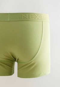 Groene katoenen boxershorts met een gladde textuur, voorzien van een zachte tailleband met de opdruk "NEXT." Korte pijpenontwerp, gestroomlijnde vorm.