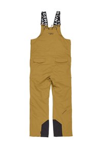 Gule vandtætte overalls med justerbare sorte stropper, to forlommer og forstærkede sorte detaljer ved anklerne.