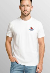 Weißes Baumwoll-T-Shirt mit einem roten Erdbeer-Design und blauer Schrift auf der Brust. Kurze Ärmel, normale Passform und glatte Textur.