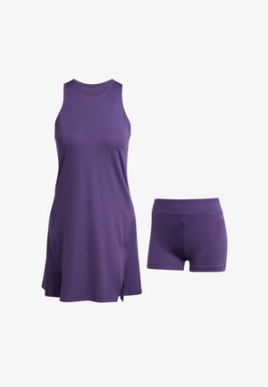 Purple athletic dress with a sleeveless design and side slits, paired with matching purple shorts. Made from a smooth, stretchy fabric.
