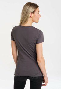 Gray short-sleeve t-shirt in soft fabric with a round neckline and fitted design, showing smooth texture and minimal seam detailing.