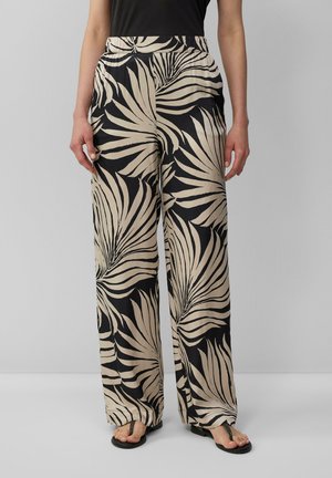 Lightweight, wide-leg trousers featuring a black and cream palm leaf pattern. Elastic waistband, smooth texture, and loose fit.