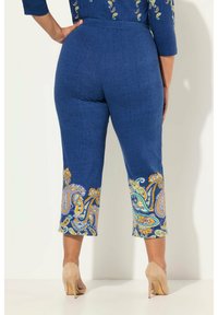 Blauwe capri-broeken met kleurrijke paisley-patronen aan de zoom, gemaakt van een gestructureerd materiaal, met een elastische tailleband en een nauwsluitend ontwerp.
