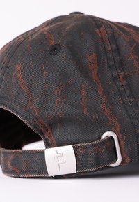 Șapcă neagră cu un design texturat ce prezintă dungi bronzate. Curea ajustabilă cu un accent metalic argintiu. Material din bumbac.