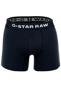 Bóxer de algodón azul marino con un diseño ajustado, cinturilla elástica con el logo "G-STAR RAW" en blanco y detalle de costura.