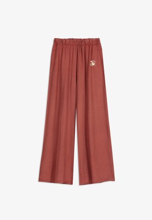Pantalones de pierna ancha en color terracota, con una cintura elástica y estirable y un pequeño parche decorativo en la parte delantera. Textura de tela suave.