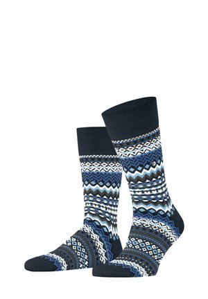 Ein Paar dunkelblaue Socken mit weißen, blauen und schwarzen geometrischen Mustern und geripptem Bündchen.