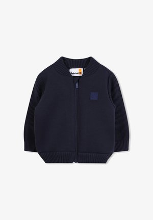Maglione zip-up blu navy con maniche e colletto a costine. Dispone di una patch con il logo Timberland sul petto. Realizzato in un tessuto morbido e strutturato.
