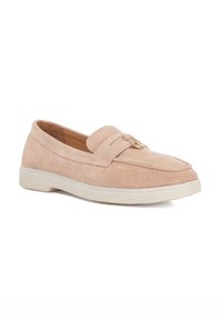 Suede loafers in light beige with a smooth texture, featuring a stitched line detail and a small decorative gold hardware accent. White sole.