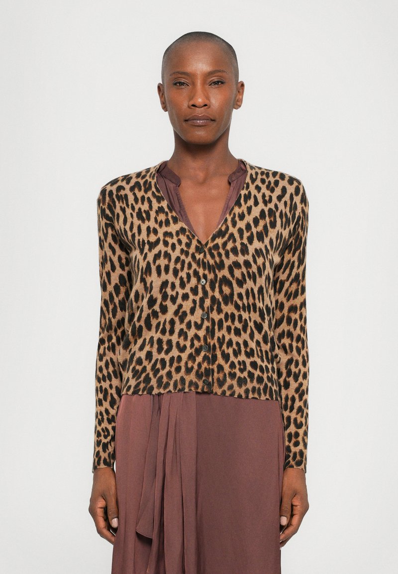 Leopard print cardigan with long sleeves, designed in tan and brown tones, featuring black buttons and a cropped hem. Worn over a deep mauve dress.