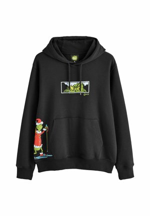Sudadera negra con un gráfico verde del Grinch con bastones de esquí y detalles en rojo del traje de Santa. Material suave de algodón con un bolsillo frontal.
