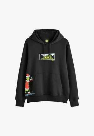 Sudadera negra con un gráfico verde del Grinch con bastones de esquí y detalles en rojo del traje de Santa. Material suave de algodón con un bolsillo frontal.