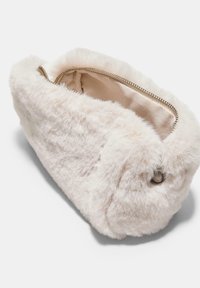 Faux fur makeup bag in light cream color, oval shape with a smooth, plush texture, zip closure, and silver-tone hardware accents.