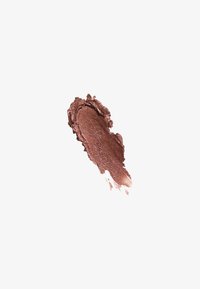 Shimmery bronze eyeshadow smear with textured edges on a white background.