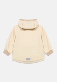 Παιδικό μπουφάν σε ανοιχτό μπεζ χρώμα με κουκούλα και ριμπ μανσέτες, εμφανιζόμενο από την πίσω πλευρά, με μια μικρή γκρι ετικέτα "Miniature" κοντά στο κάτω τελείωμα.
