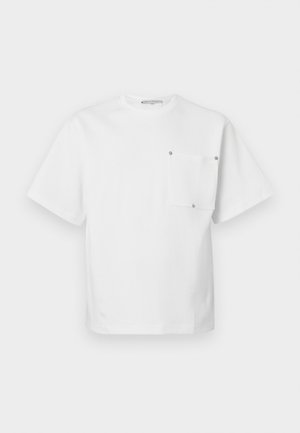 Weißes Kurzarm-T-Shirt mit Rundhalsausschnitt und einer rechteckigen Tasche auf der linken Brust, die mit vier Metallnieten befestigt ist.