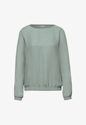 Blusa verde chiaro a maniche lunghe con scollo rotondo e orlo elastico. Realizzata in tessuto liscio con una vestibilità comoda.
