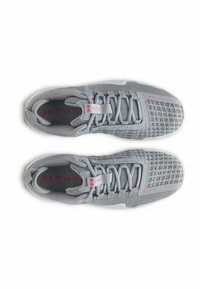 Light gray athletic shoes with a textured mesh upper, contrasting plastic accents, and red detailing. Features traditional lacing system.