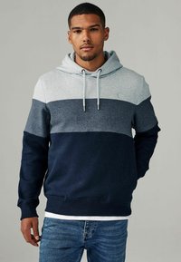Hoodie met een kleurblokontwerp in lichtgrijs, marineblauw en donkerblauw. Voorzien van ribgebreide manchetten en zoom, en details met een trekkoord.