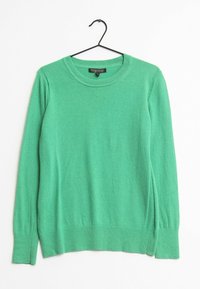 Maglione verde a maniche lunghe con scollo rotondo appeso a una gruccia nera su uno sfondo bianco, etichetta che riporta Banana Republic.