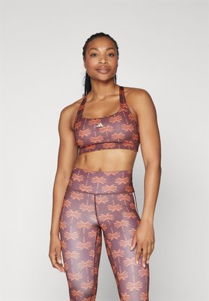 Sportsbh og høyt liv leggings i brunt med oransje palmemønster; laget av glatt, elastisk materiale; atletisk design og passform.