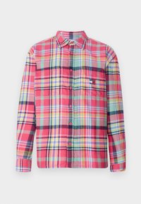 Red and multi-colored plaid long-sleeve button-up shirt, featuring a collar, chest pocket, and soft texture with varied check patterns.