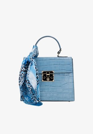 Blue crocodile-textured handbag with top handle and silver lock, adorned with a tied blue and black patterned silk scarf.