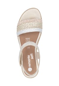 Woven strap sandal with soft beige, white, and light pink colors. Features a suede upper and a flexible sole. Logo on insole.