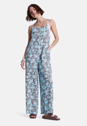 Kombinezon w kwiatowy wzór z jasnoniebieskim tłem, brązowymi liśćmi i kwiatami, szerokimi nogawkami, regulowanymi ramiączkami oraz bocznymi kieszeniami.