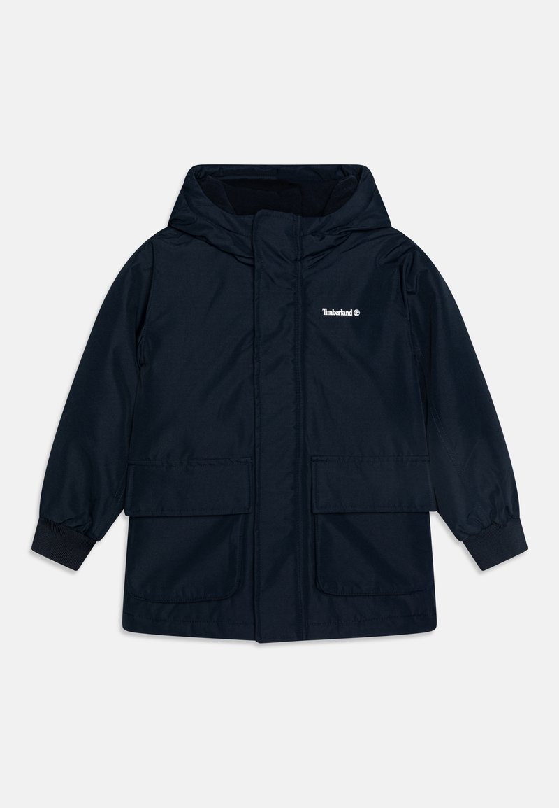 Navy blue waterproof jacket made of textured fabric, featuring a hood, two front pockets, and elastic cuffs. Timberland logo displayed.