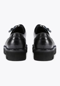 Zwarte leren dresschoenen met een ronde vorm, dikke zwarte rubberen zolen en decoratieve veters met een blauwe accent. Gladde textuur, minimale stiksels.