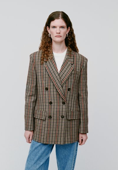 Double-breasted plaid blazer in brown, grey, and red tones made of textured fabric; features two front pockets and black buttons.